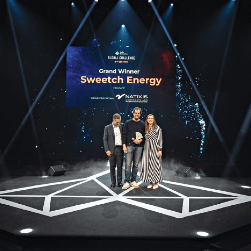 The Swatch Energy team celebrates together at the award ceremony, showcasing their achievements and teamwork.