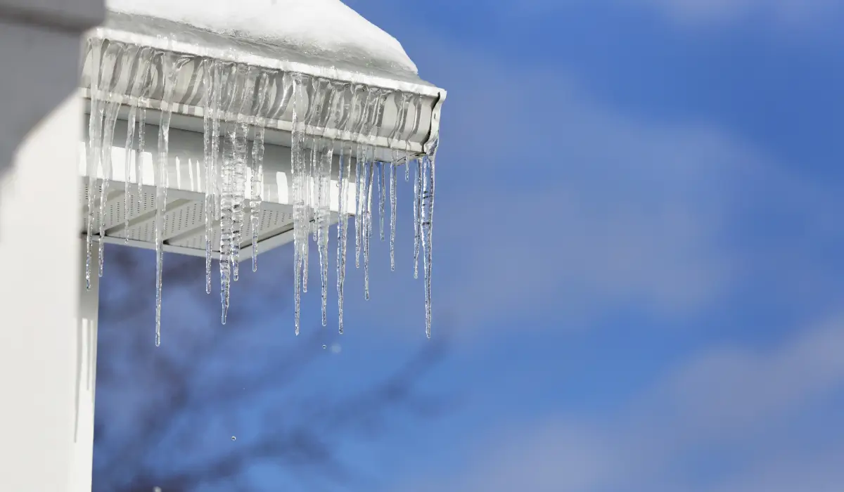 Roof Inspection highlighting ice dams forming along gutters during winter freeze conditions.