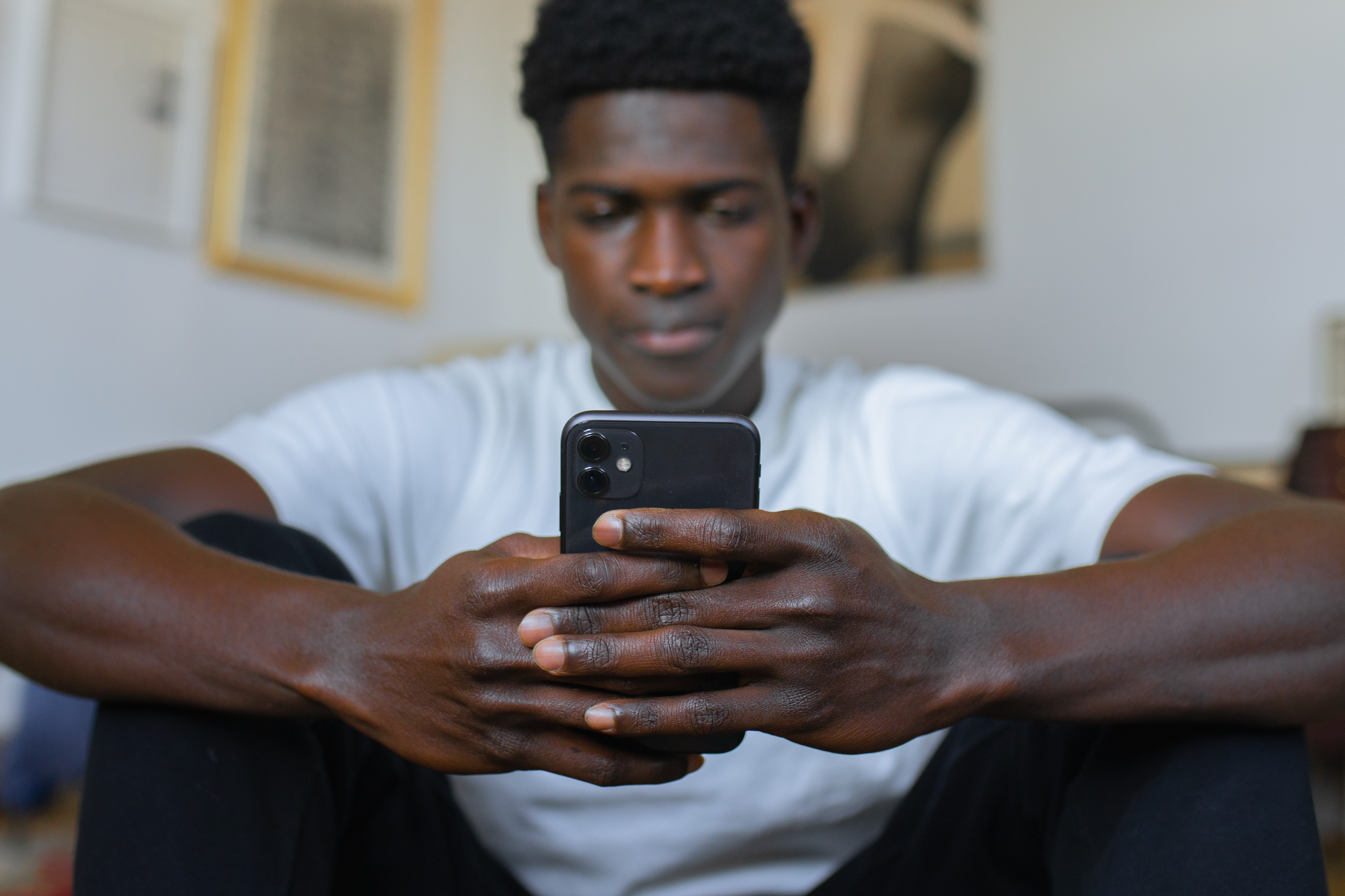 A Ghanaian man saerching online on his phone for information