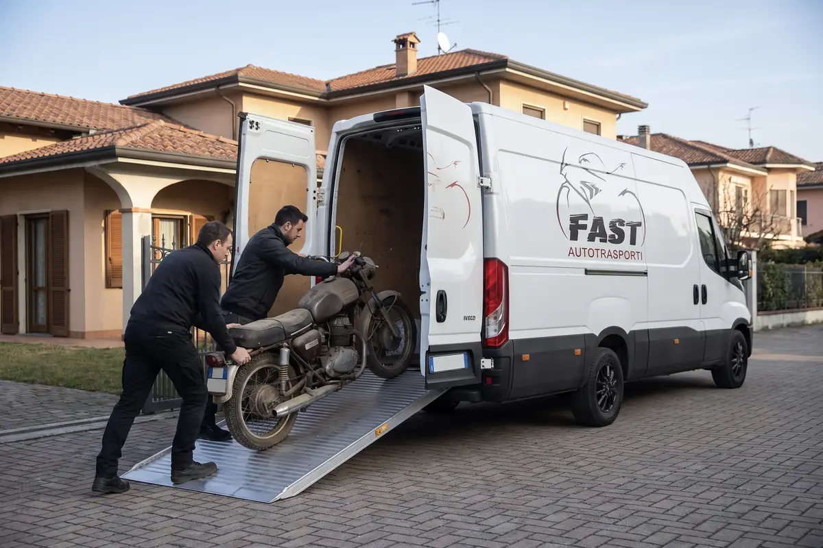 Due operatori FAST caricano a rampe una moto non marciante nel furgone