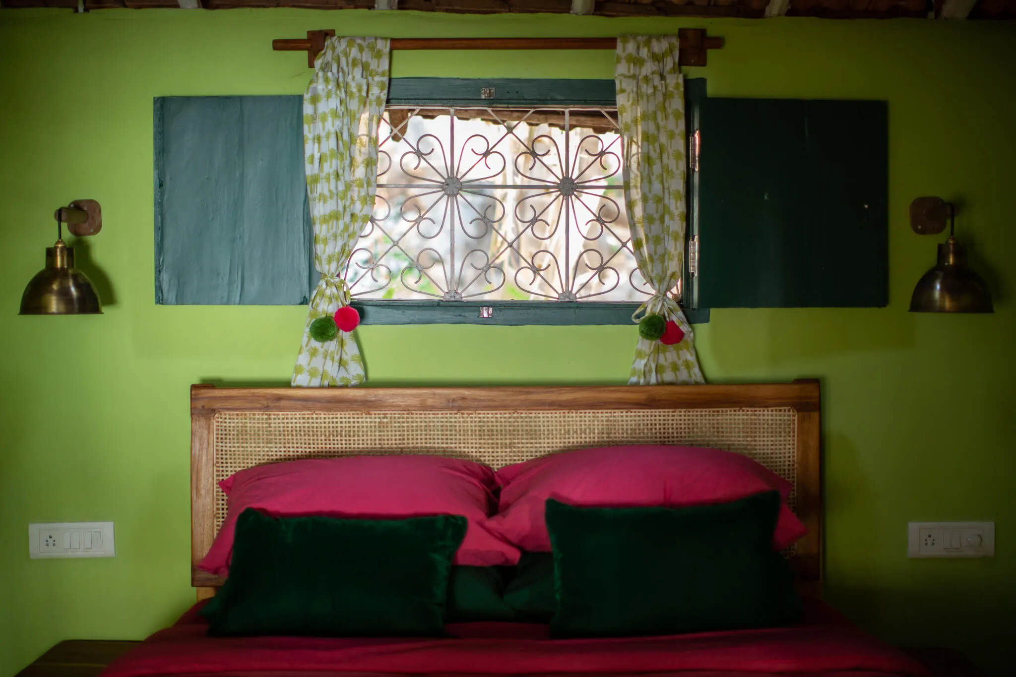 Block-print cushions beneath a lattice window at Casa Jaali