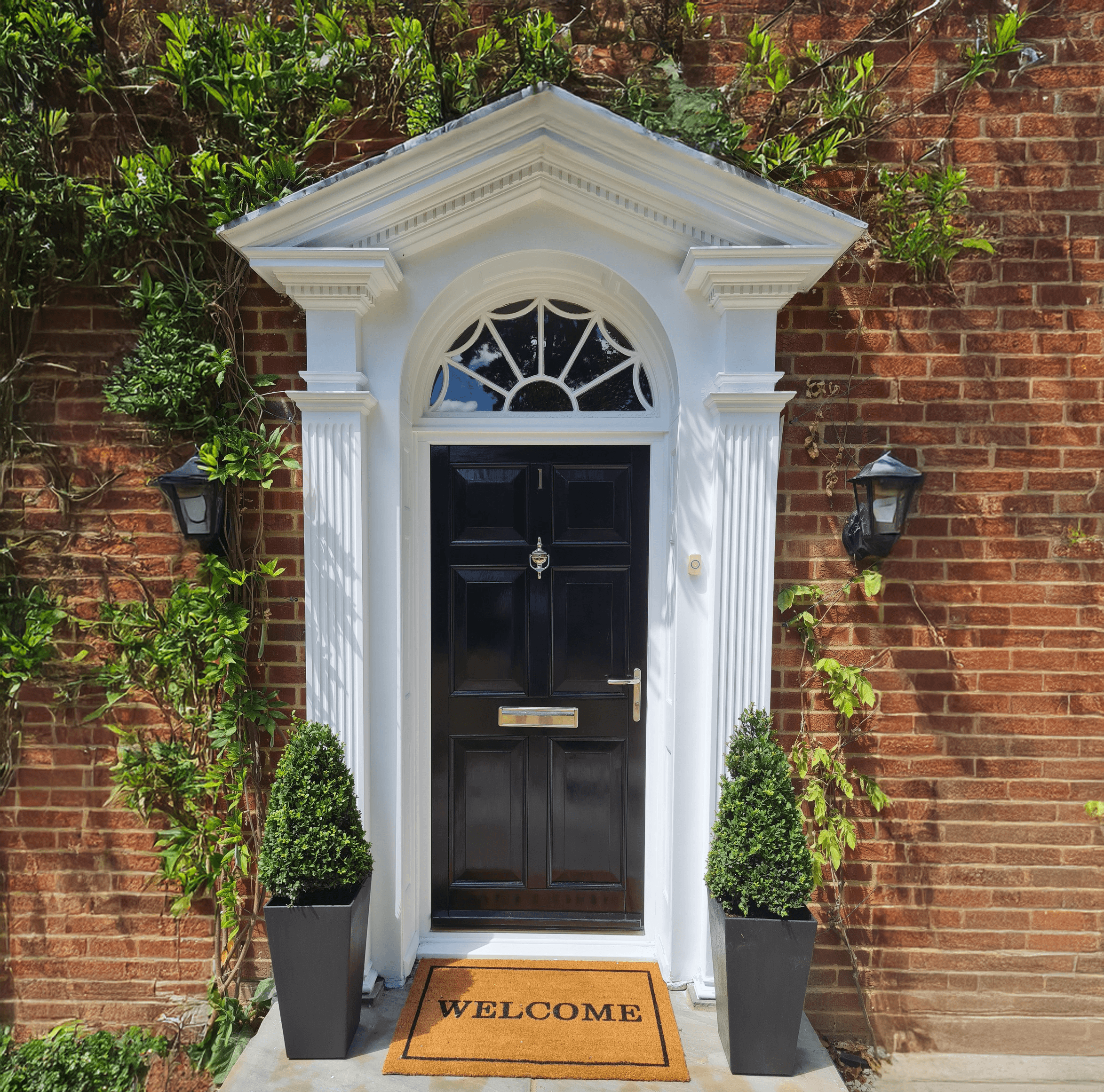 red bicycle parked beside black metal gate in front house