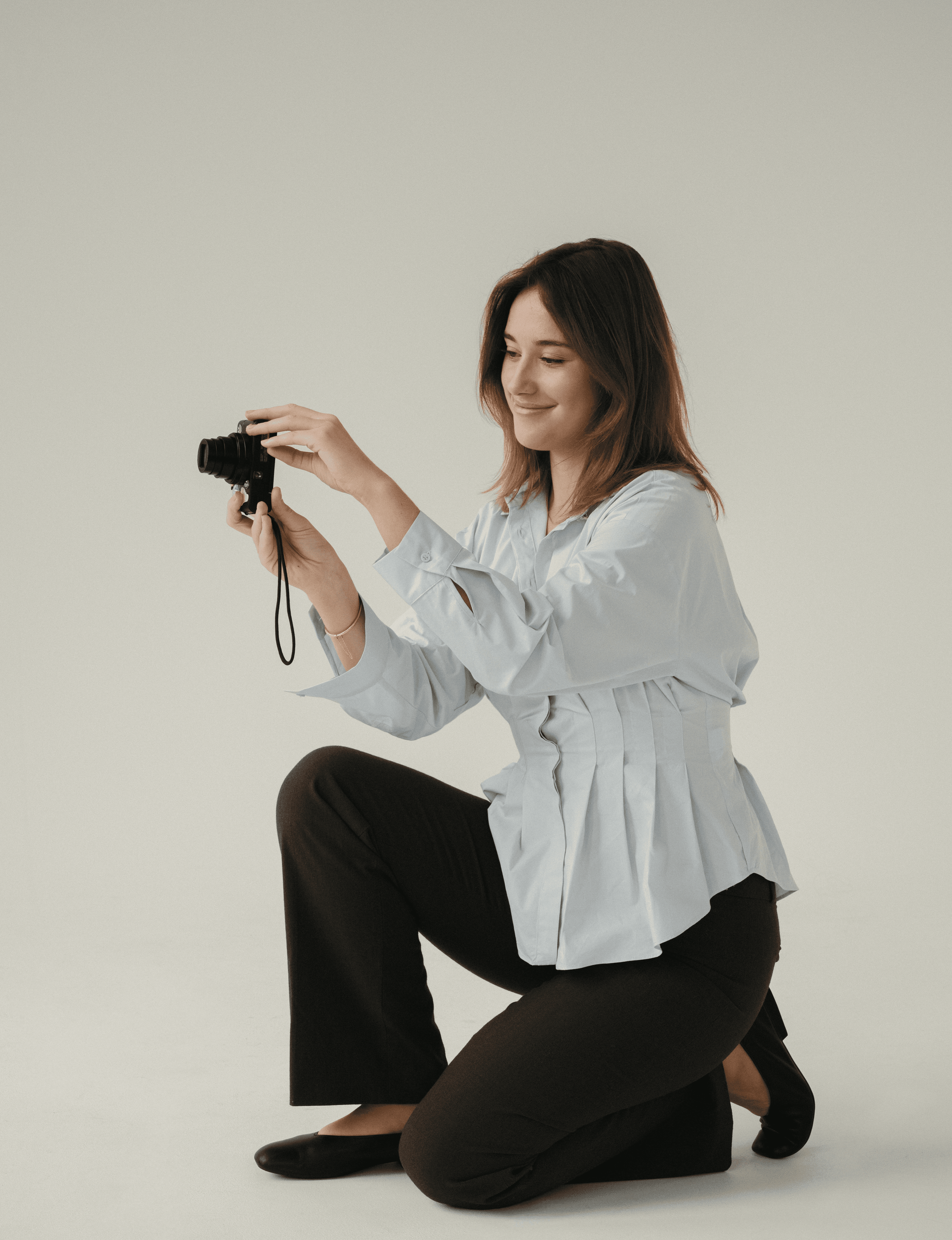 Portrait of a person in a pink sweater against a light background