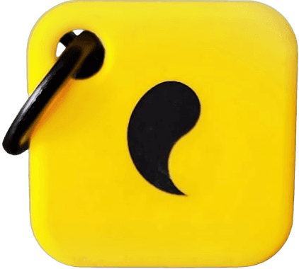 Unpluq phone-blocking device, a yellow square keychain tag with a black comma-shaped logo and a metal ring.