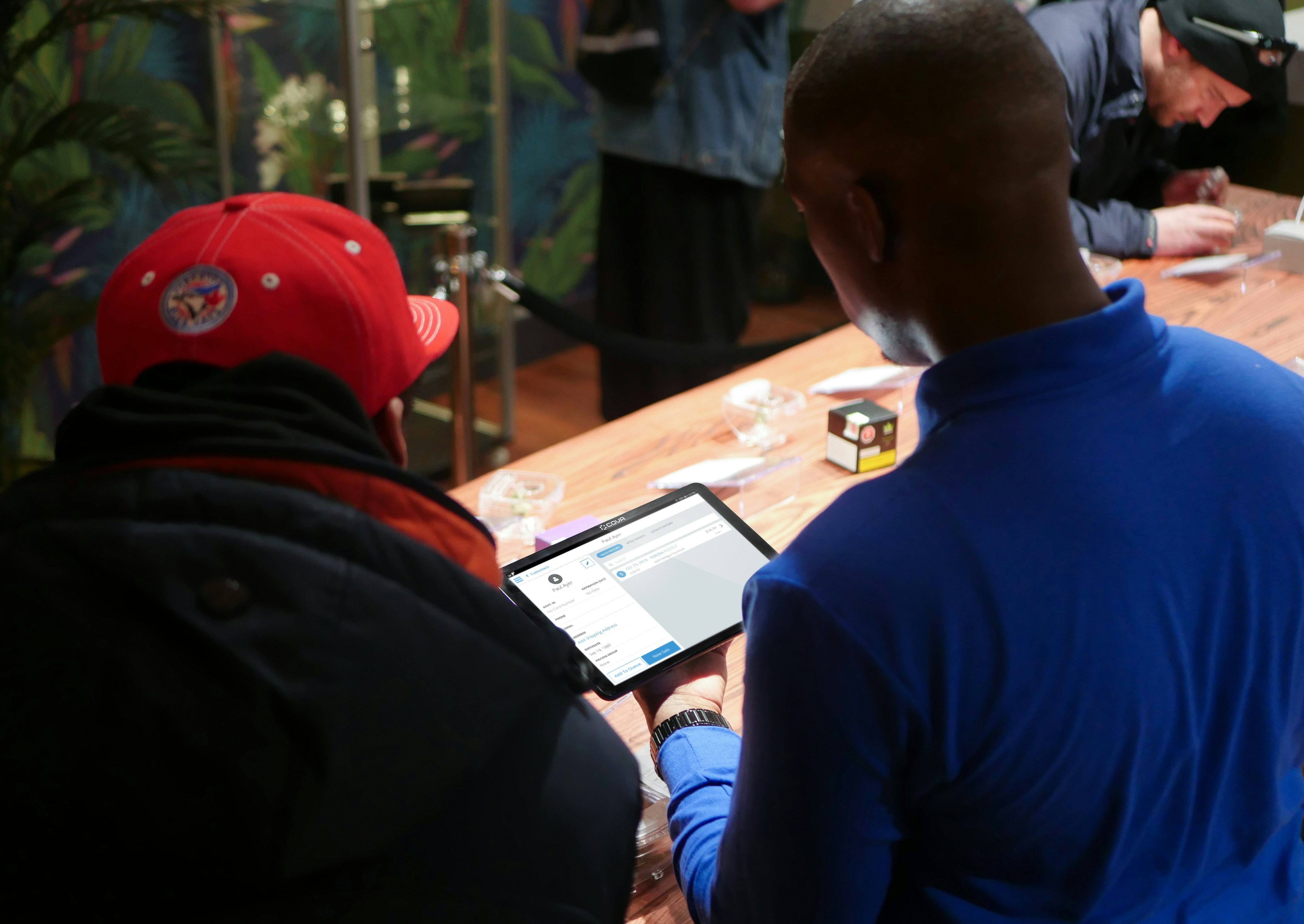 a group of people sitting around a wooden table