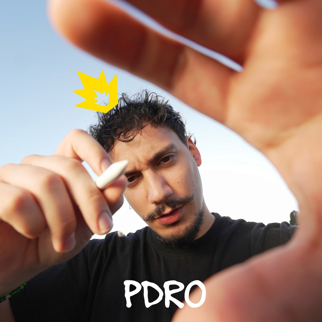 Woman working on a laptop computer at a table in a bright room.