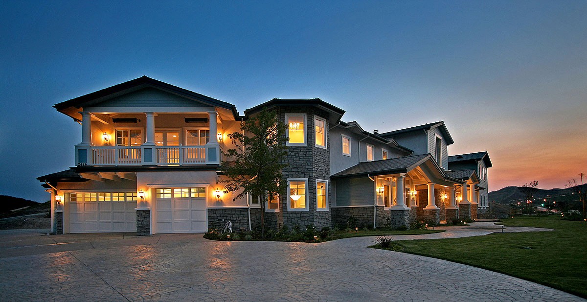 Exterior view of the Craftsman home at dusk, showcasing the warm lighting and detailed architecture.