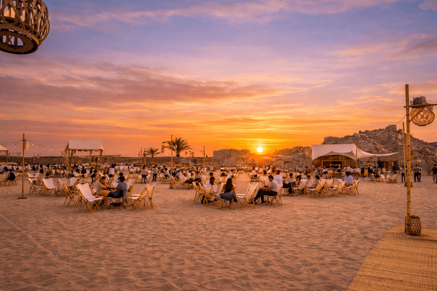 Guests relaxing at a desert camp during the Dune Quest Tours evening desert safari in Dubai at sunset