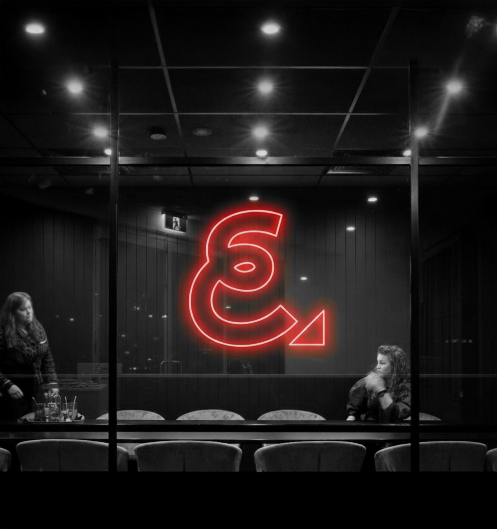 Young black woman witting at the table working on a laptop