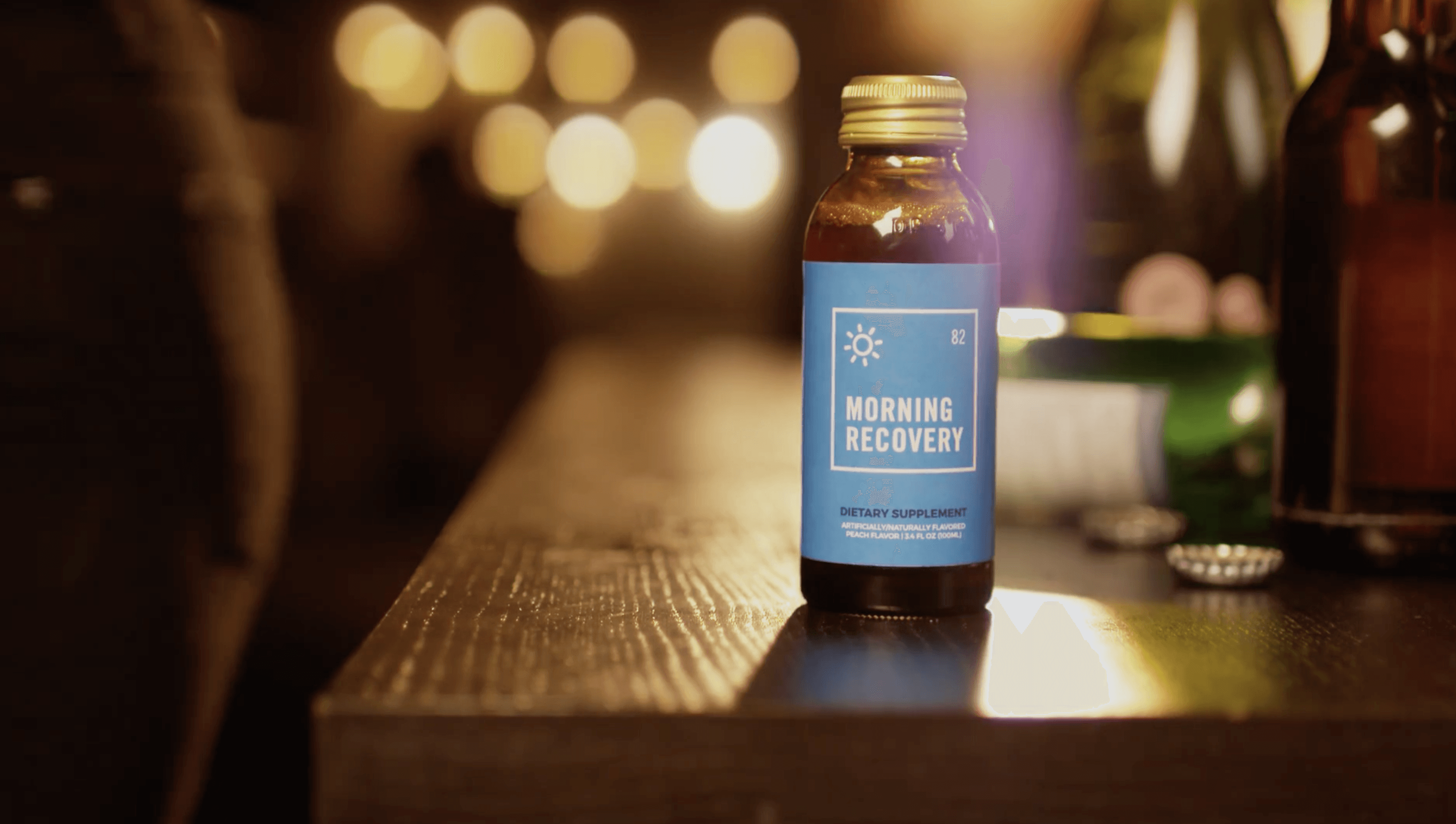 Sunlight glints off a canal with buildings and boat.