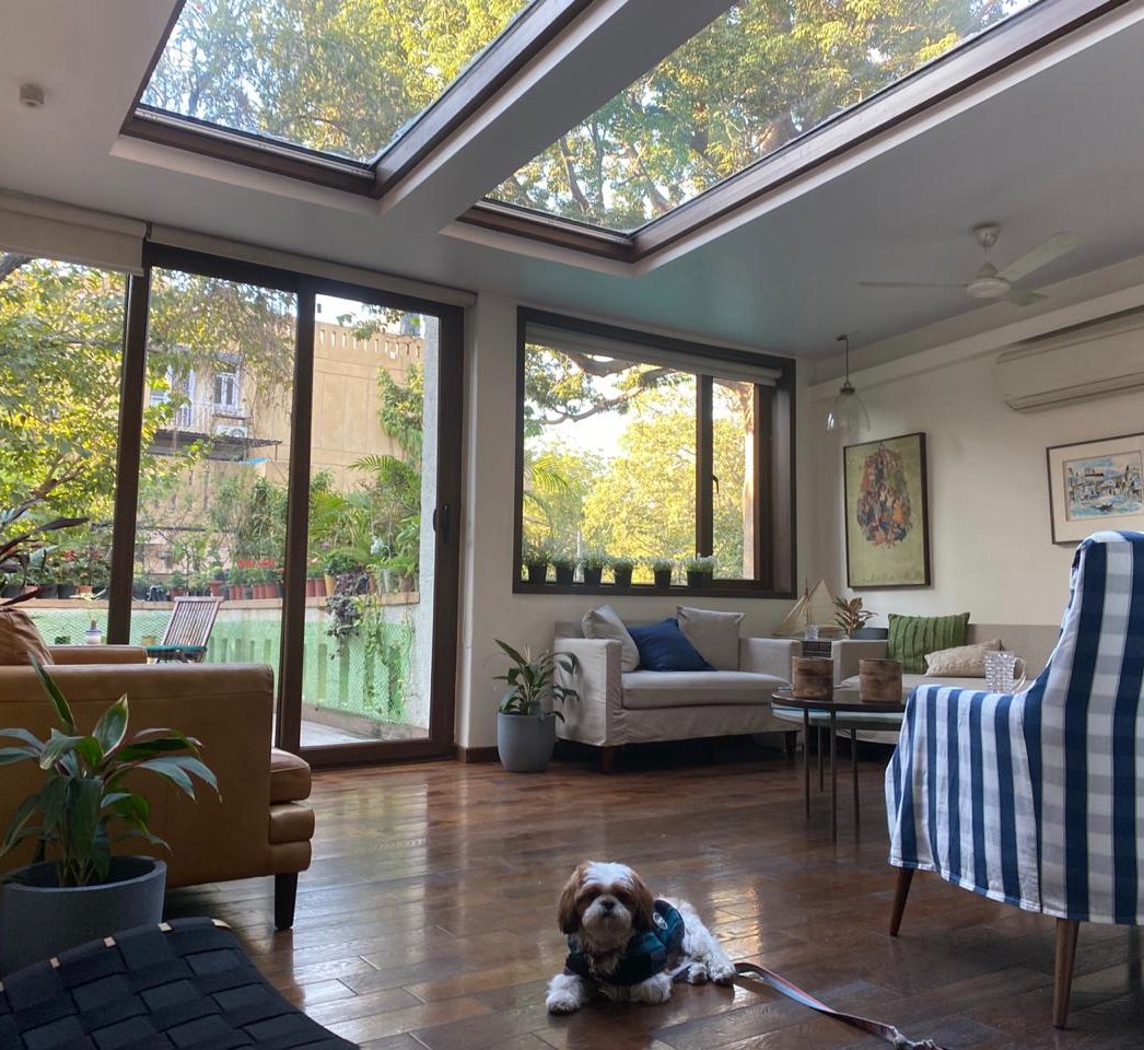 Nature-inspired preschool entrance with sculptural tree partitions and suspended green leaf ceiling panels.