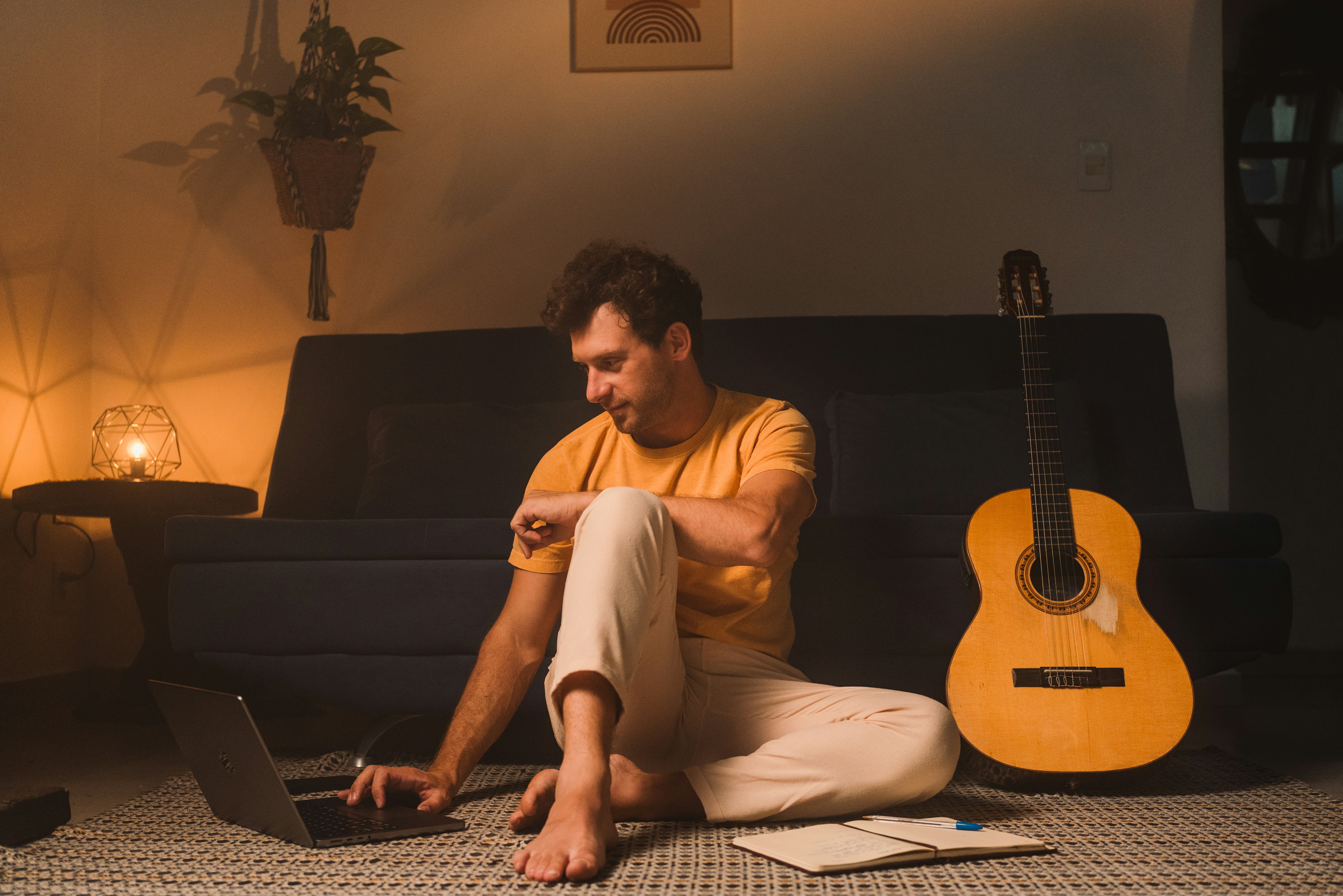 man with guitar and computer - Music production setup