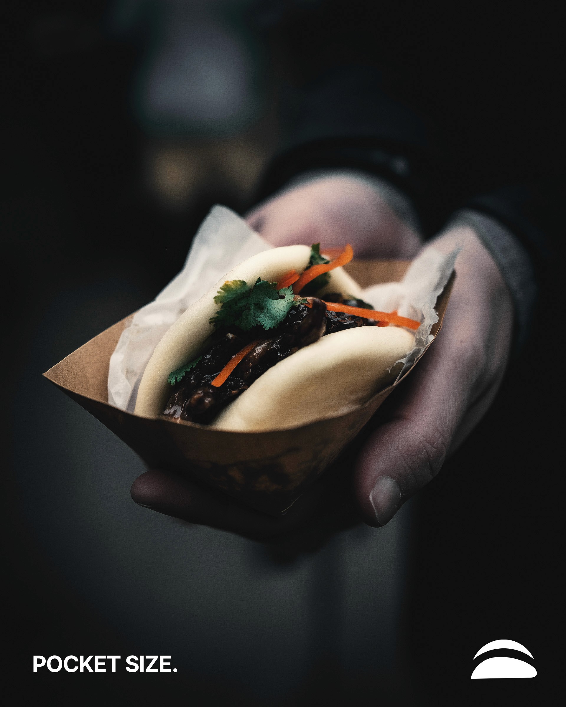 A stack of three folded linen towels in beige, oatmeal, and charcoal tones, resting on a cork mat next to wooden poles. Strong vertical shadows are cast against the textured white wall behind them.