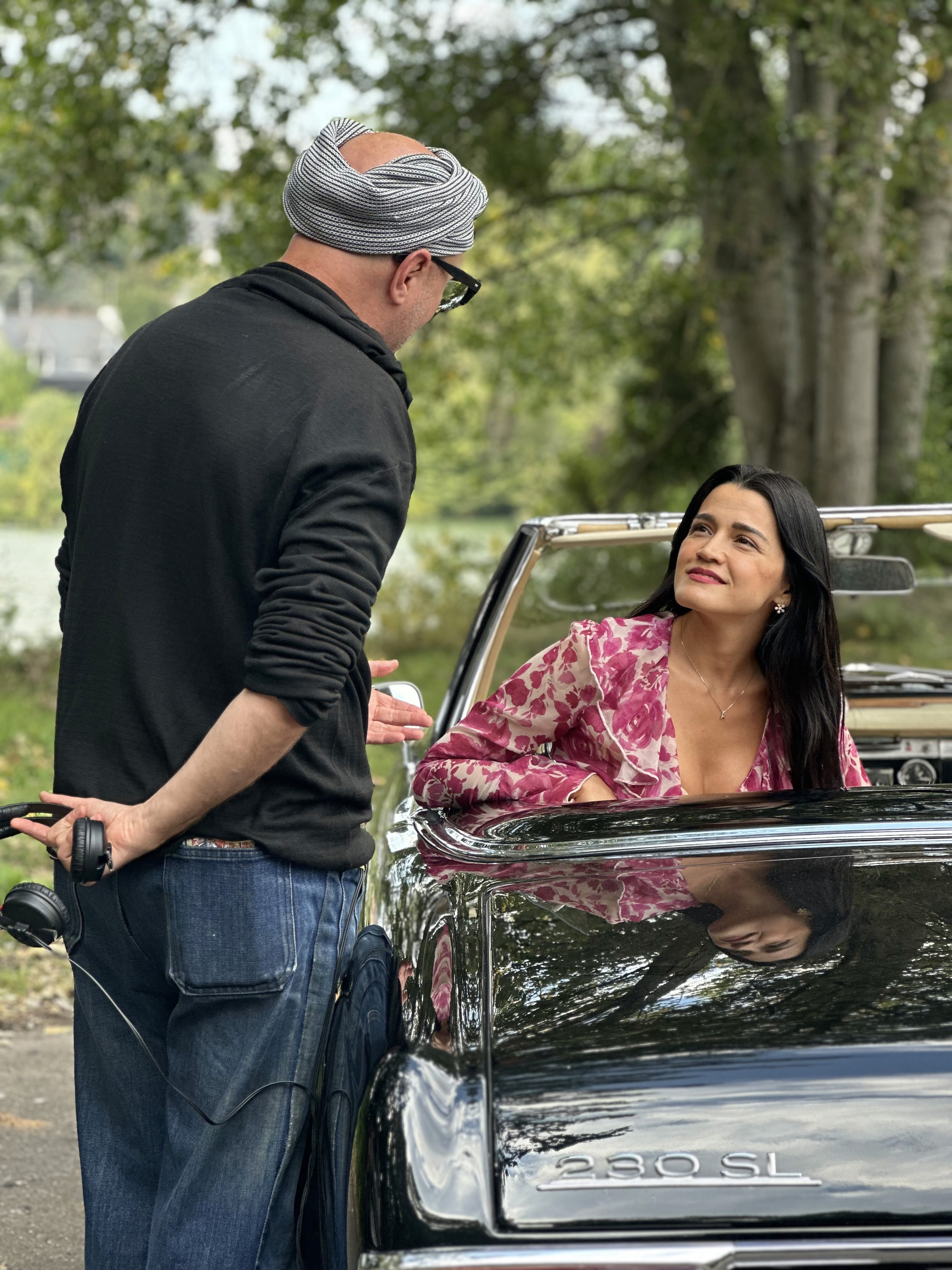 Woman in pink leather jacket crouching outdoors at night