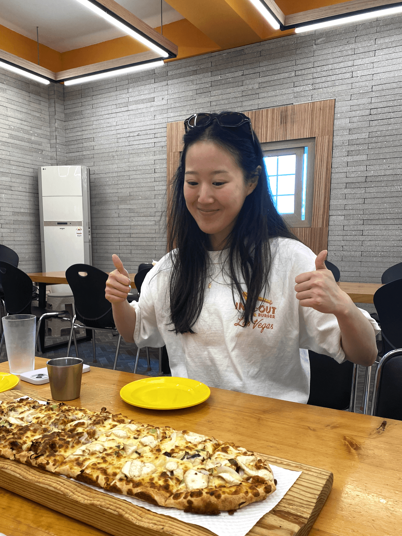 A picture of Cathy Wang with a long bulgogi pizza