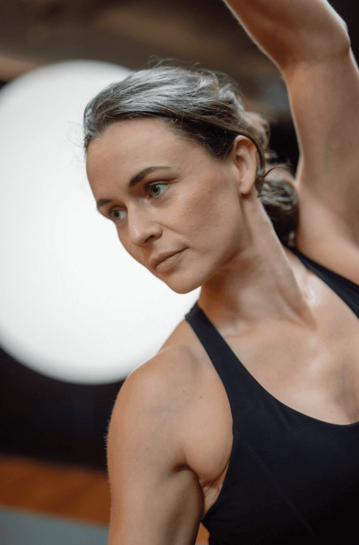 Black cosmetic product bottle against a dark background