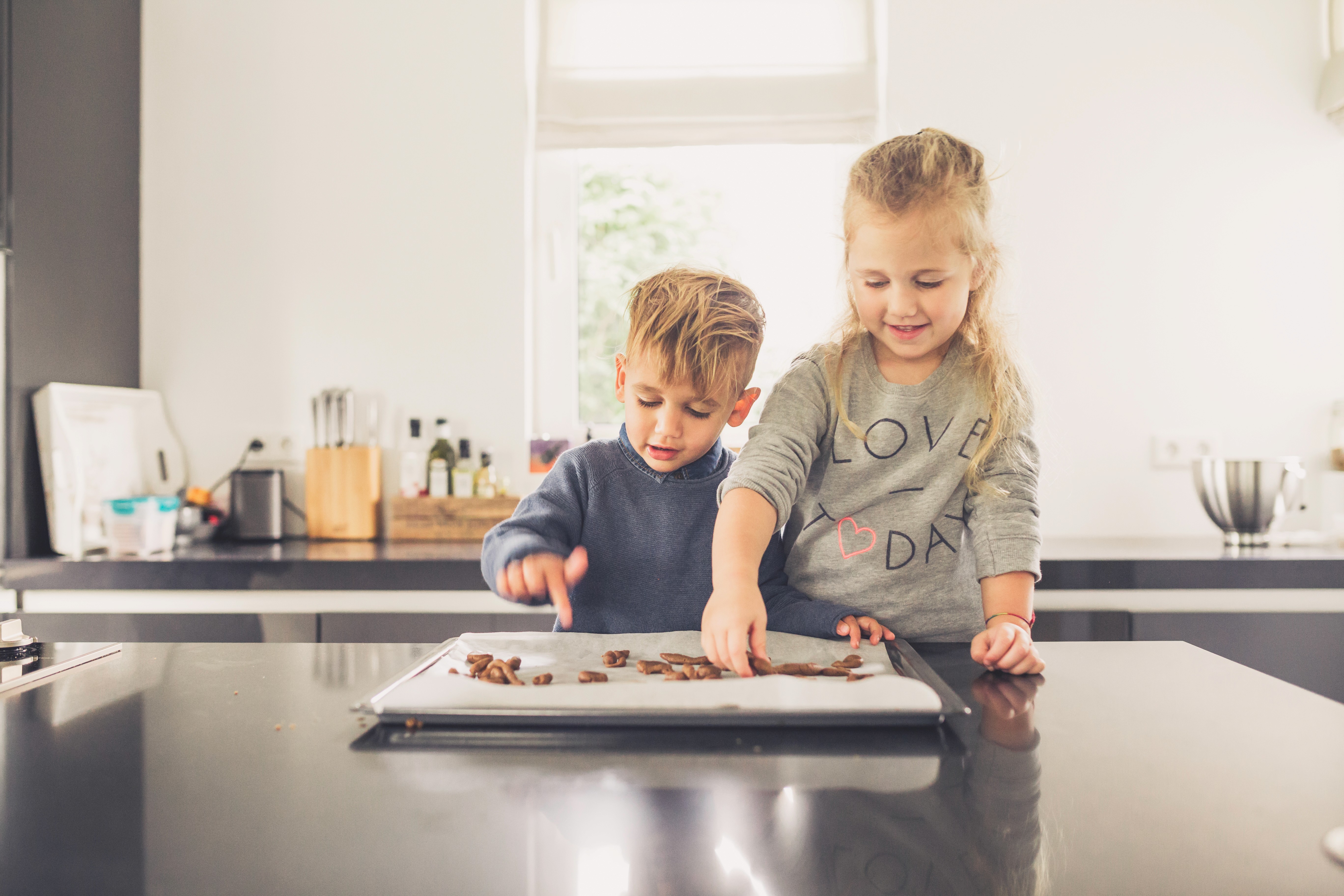 Children bake their own spiced cookies.