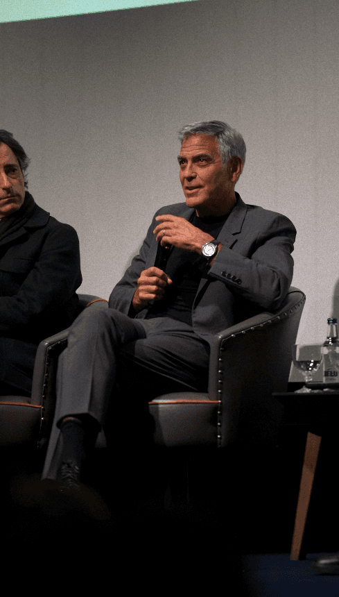 Bride and groom walking on street at night