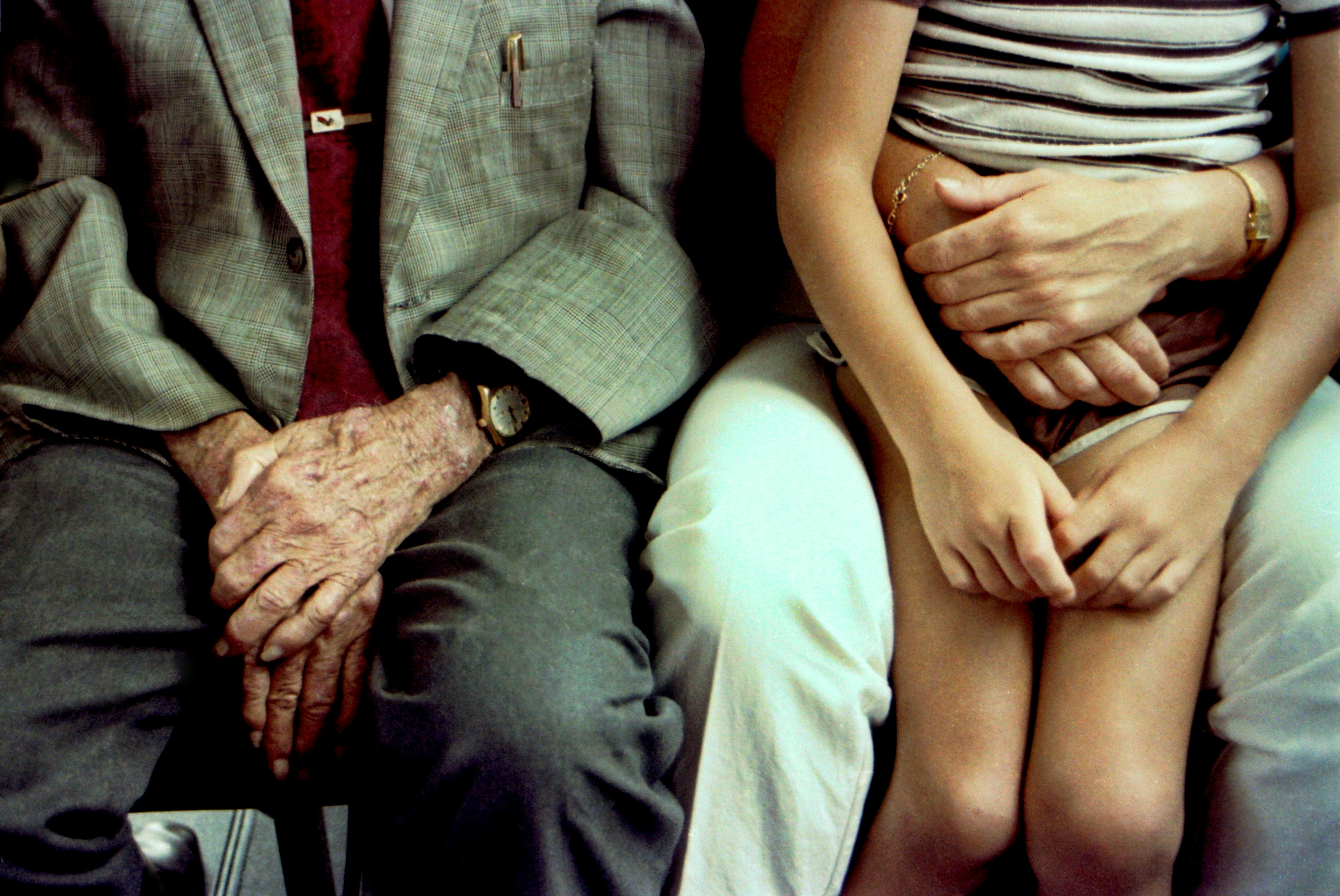 Grandfather's hands comfort a child.