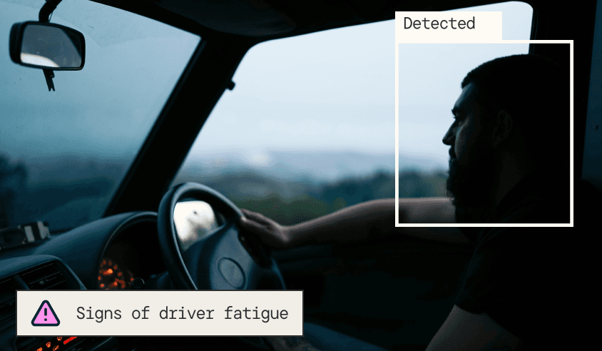 Interior vehicle view of a driver's silhouette with a pink "Detected" box and a warning label for "Signs of driver fatigue."