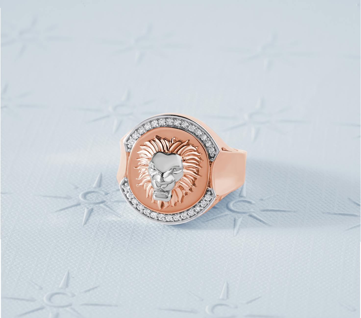 Lion head ring with diamonds in rose gold, showcasing luxurious design and artistry.