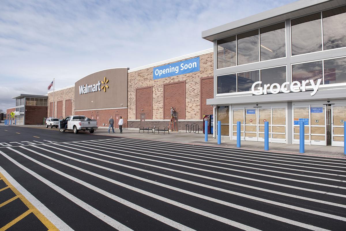 The exterior of a Walmart store #2667 in Dallas, TX with a sign that says "Opening Soon." Several people are near the entrance under a "Grocery" sign, and a few vehicles are parked nearby.