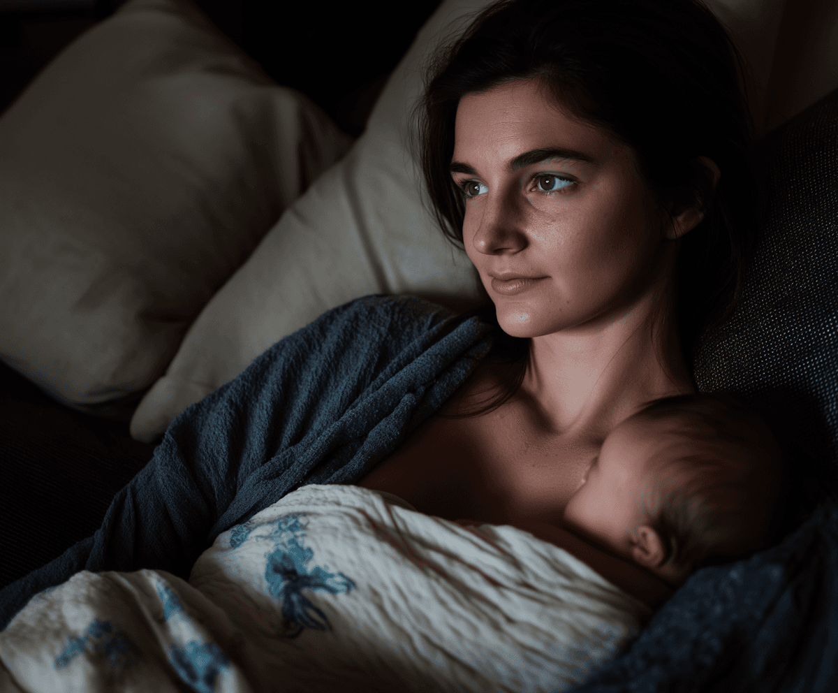 A parent settling a baby to sleep in the evening
