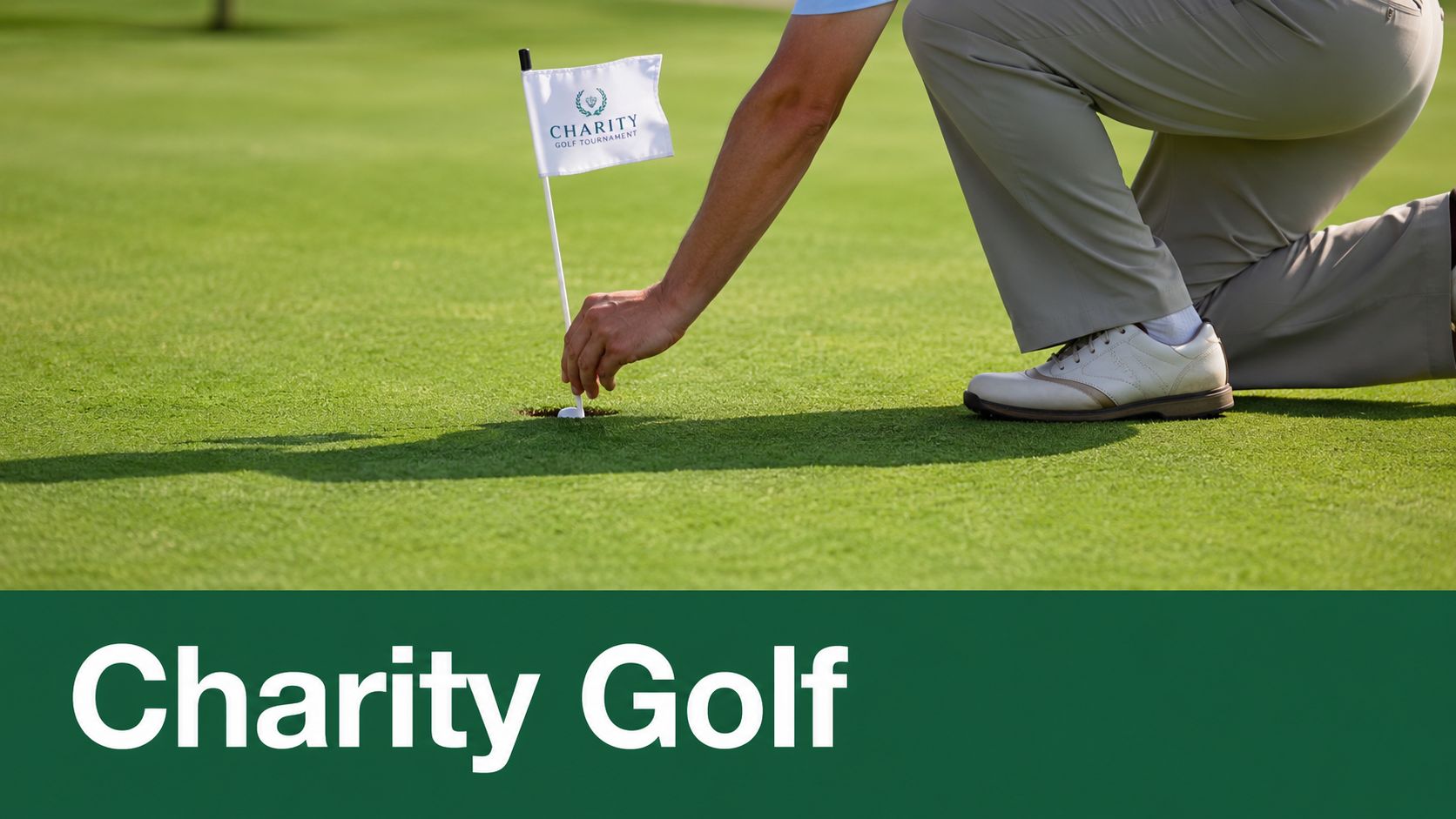A golfer kneeling on the green reaches down to pull a charity golf tournament flag from the cup.