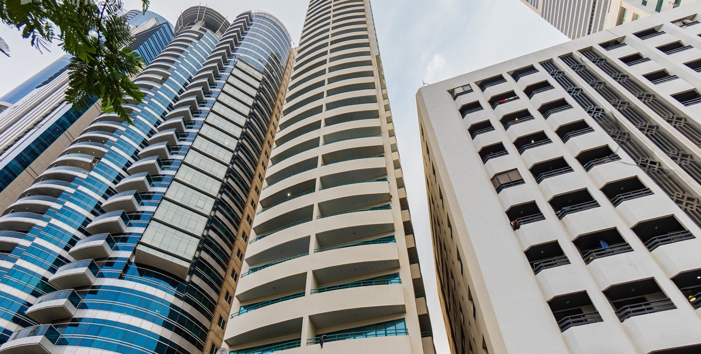 Low angle shot of White Swan Building and neighboring high-rises, perfect for urban real estate listings.