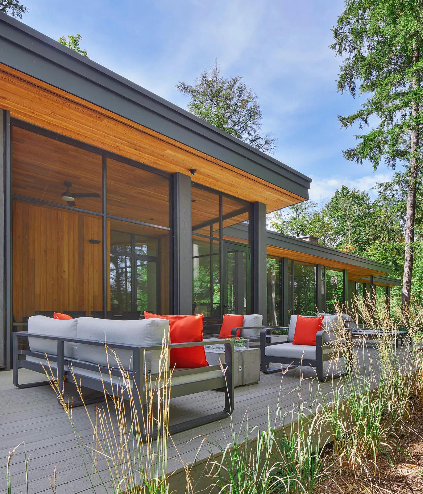 Large cottage deck with fully screened in porch on a custom modern cottage.