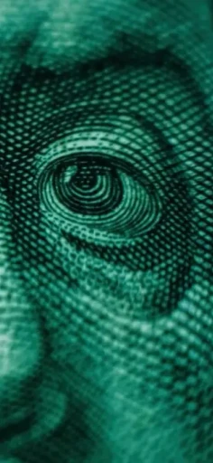 A dollar bill zoomed in representing the greed of force placed home owner insurance in the usa