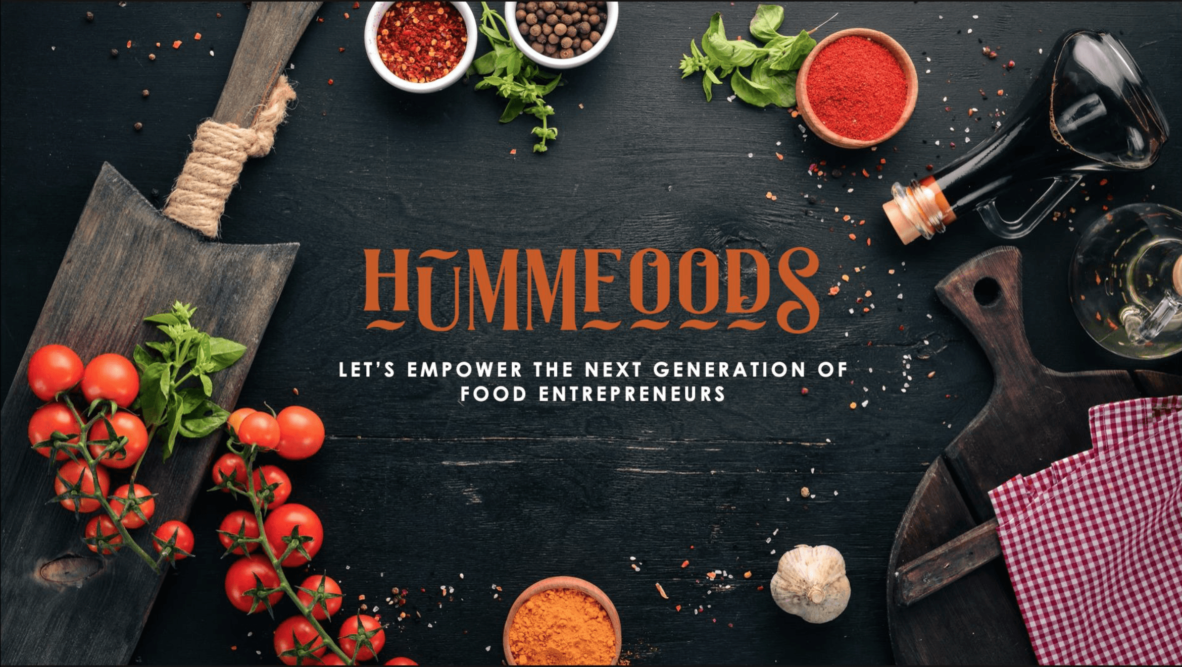 Overhead image of cutting board and raw ingredients such as tomatoes, black peppercorn, crushed chili flakes, garlic and balsamic vinegar.