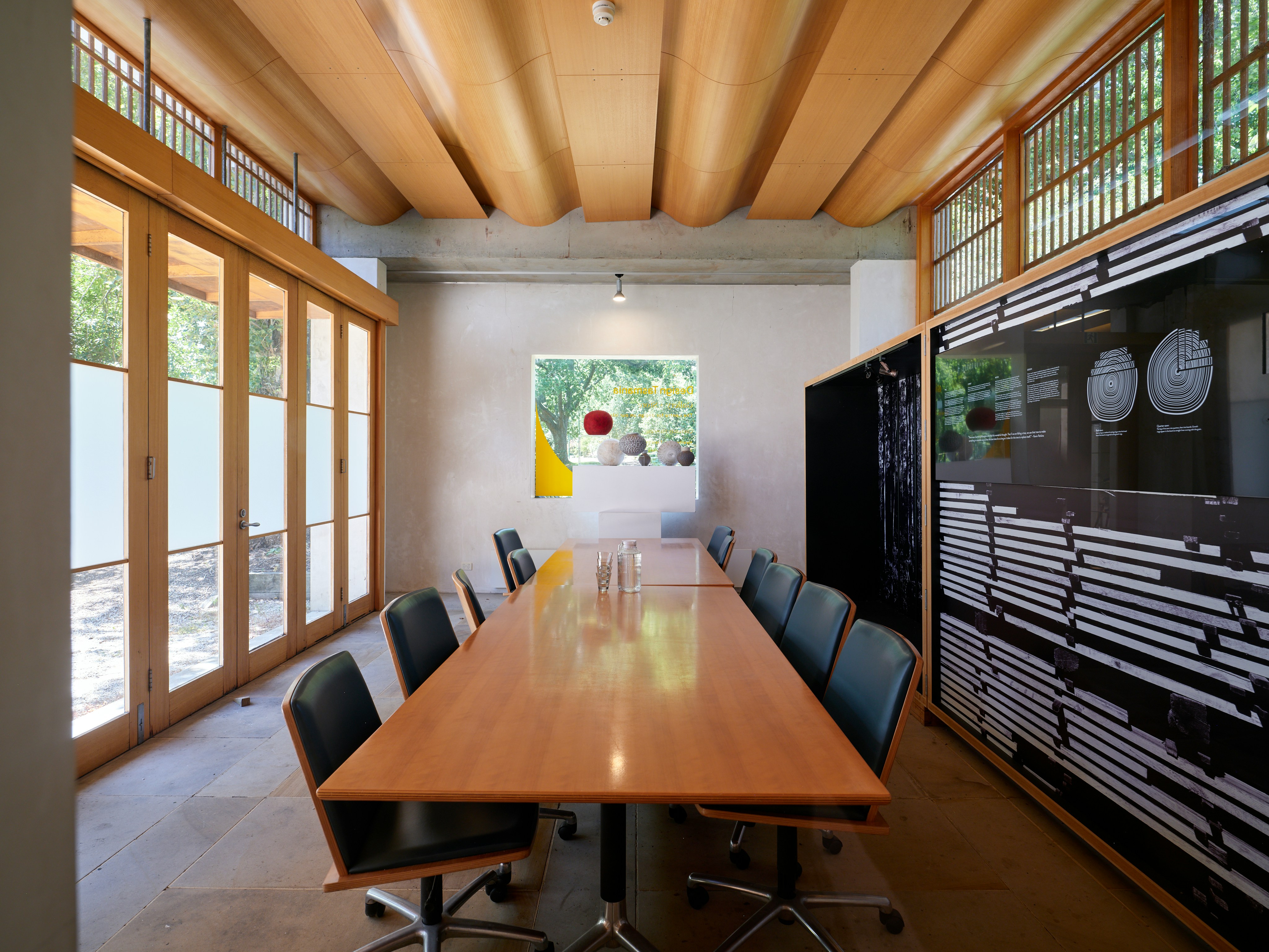 Modern conference room with long wooden table and chairs