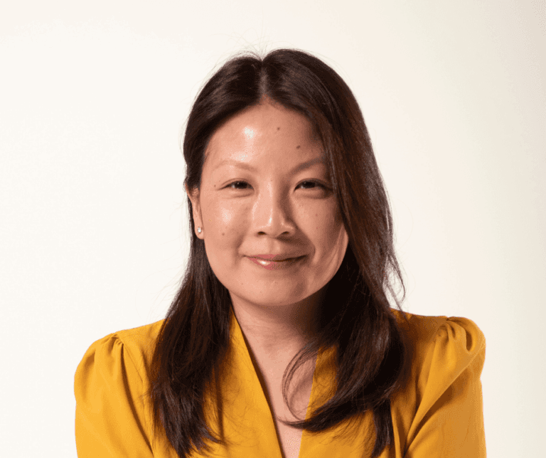 Karen Ko, Florence's Chief Financial Officer, smiling and wearing a yellow top against a warm-toned background
