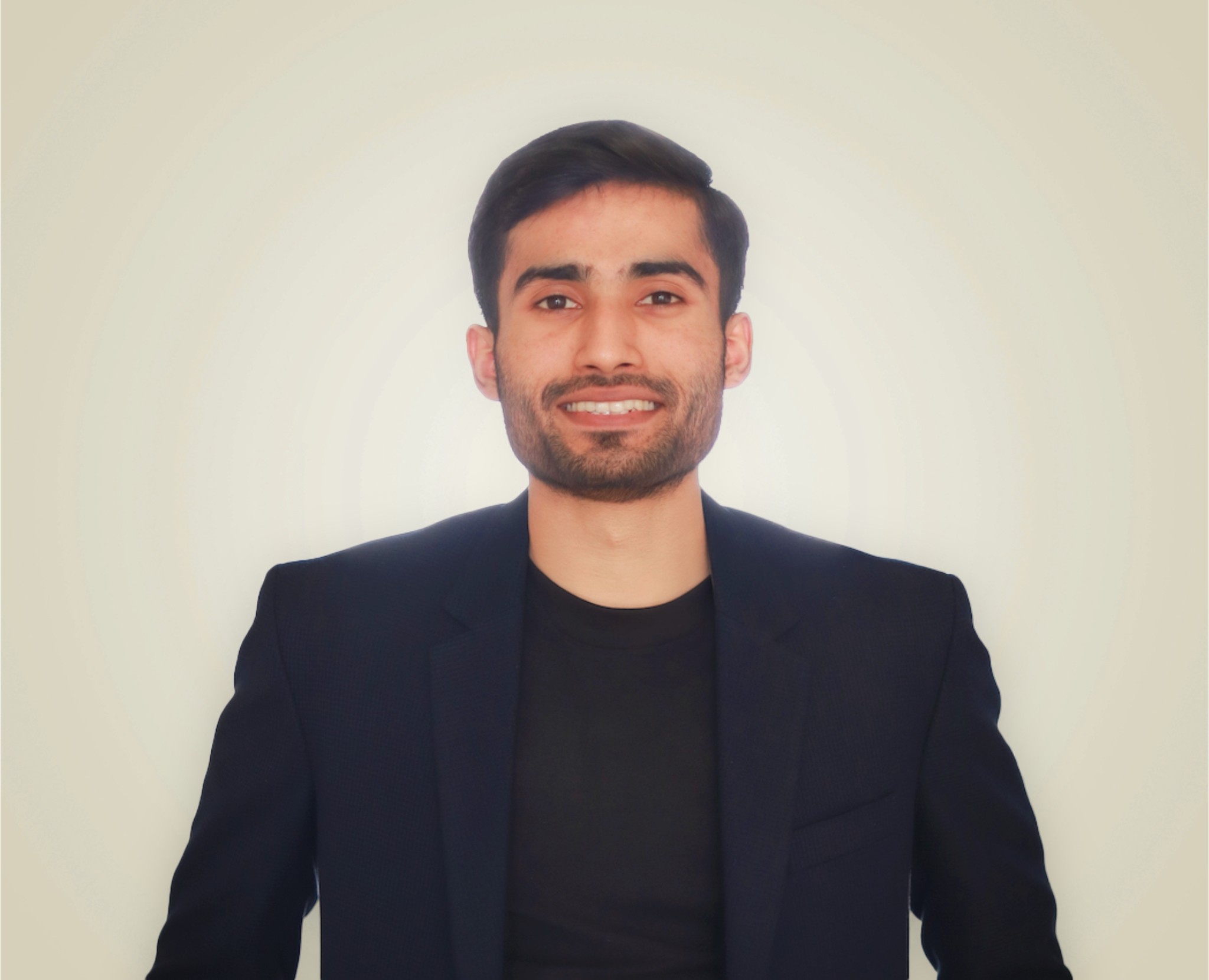 Zubair Ibrahim, Content Marketing Specialist with 3 plus years of experience, smiling in a professional black blazer against a neutral background
