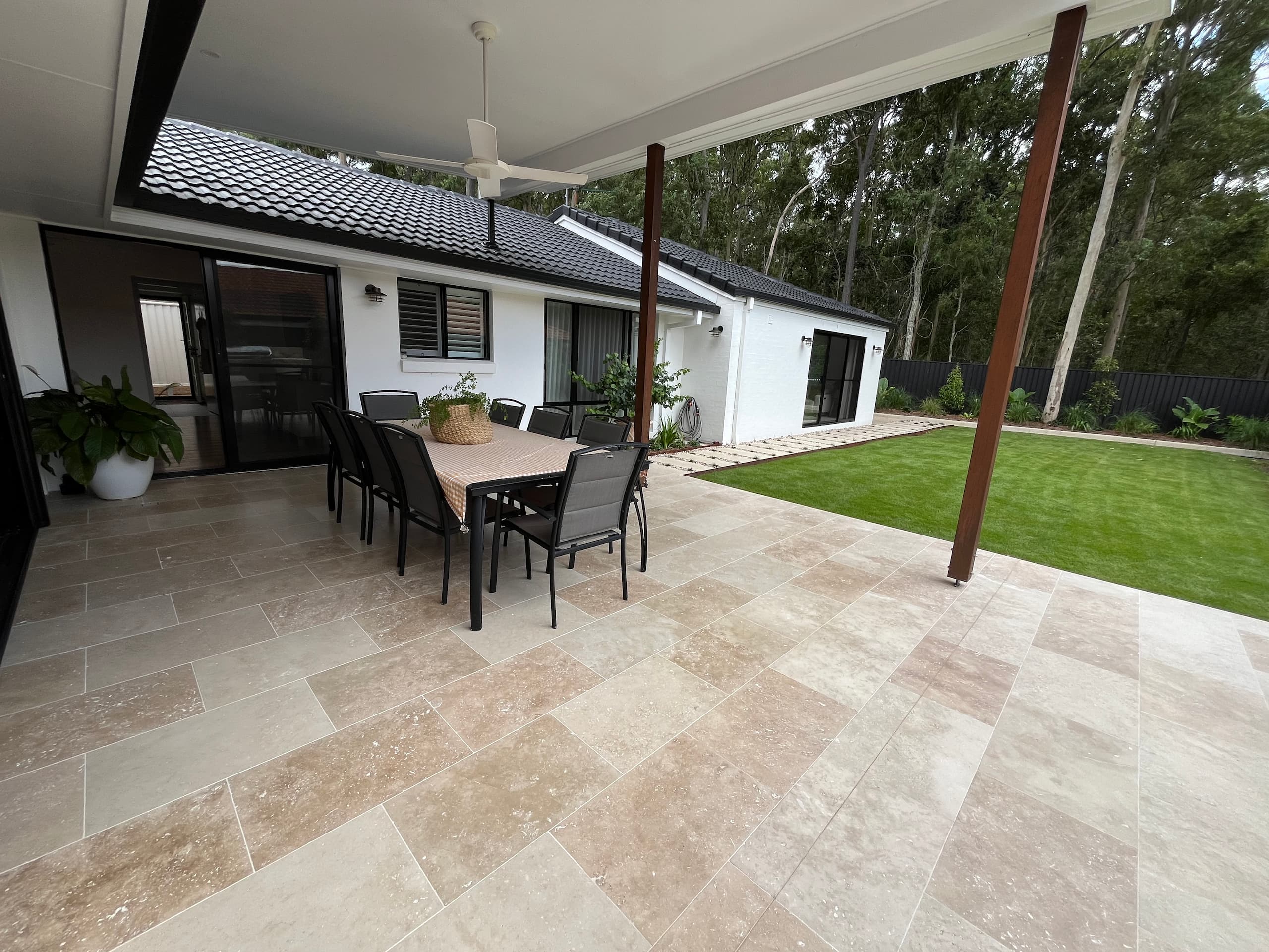 Outdoor living area with tiled patio and dining set in a renovated Brisbane home