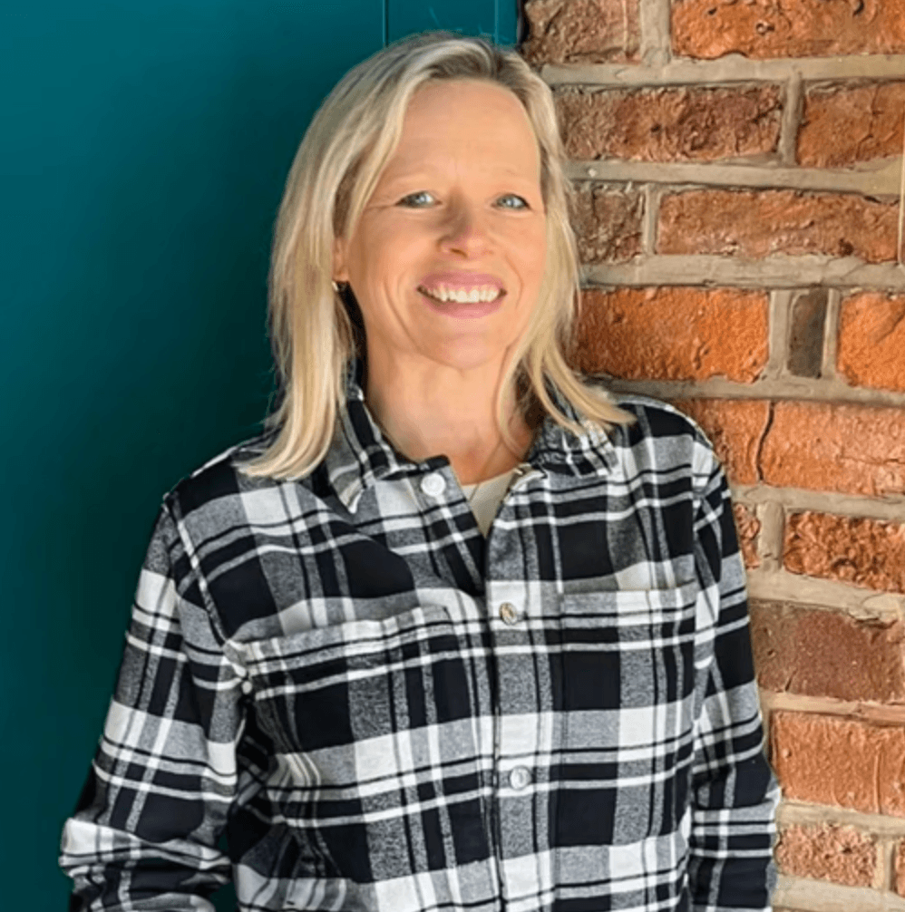 A person on a cozy studio smiling
