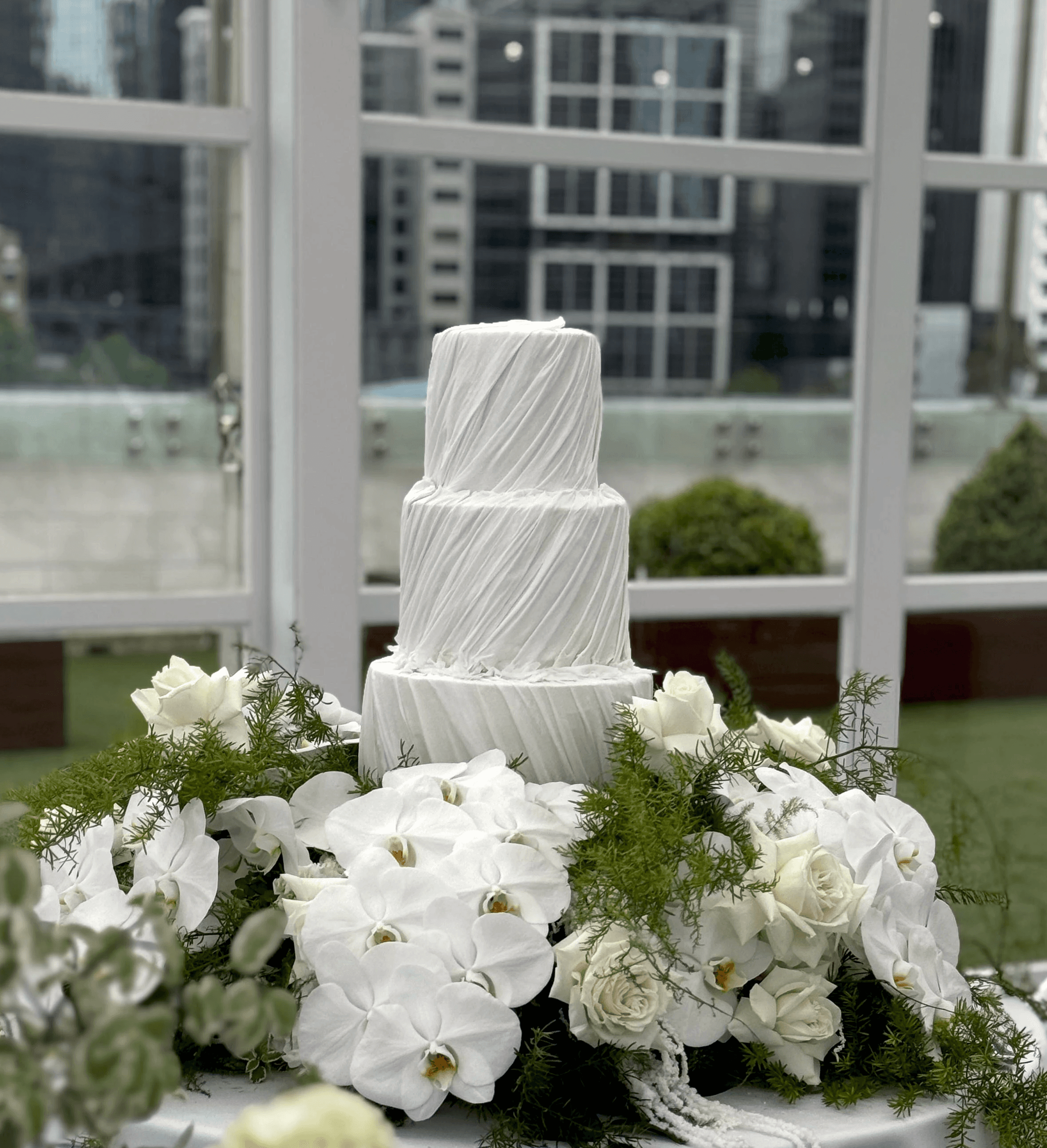 three tire wedding cake with velvet finish and cascading draping details.