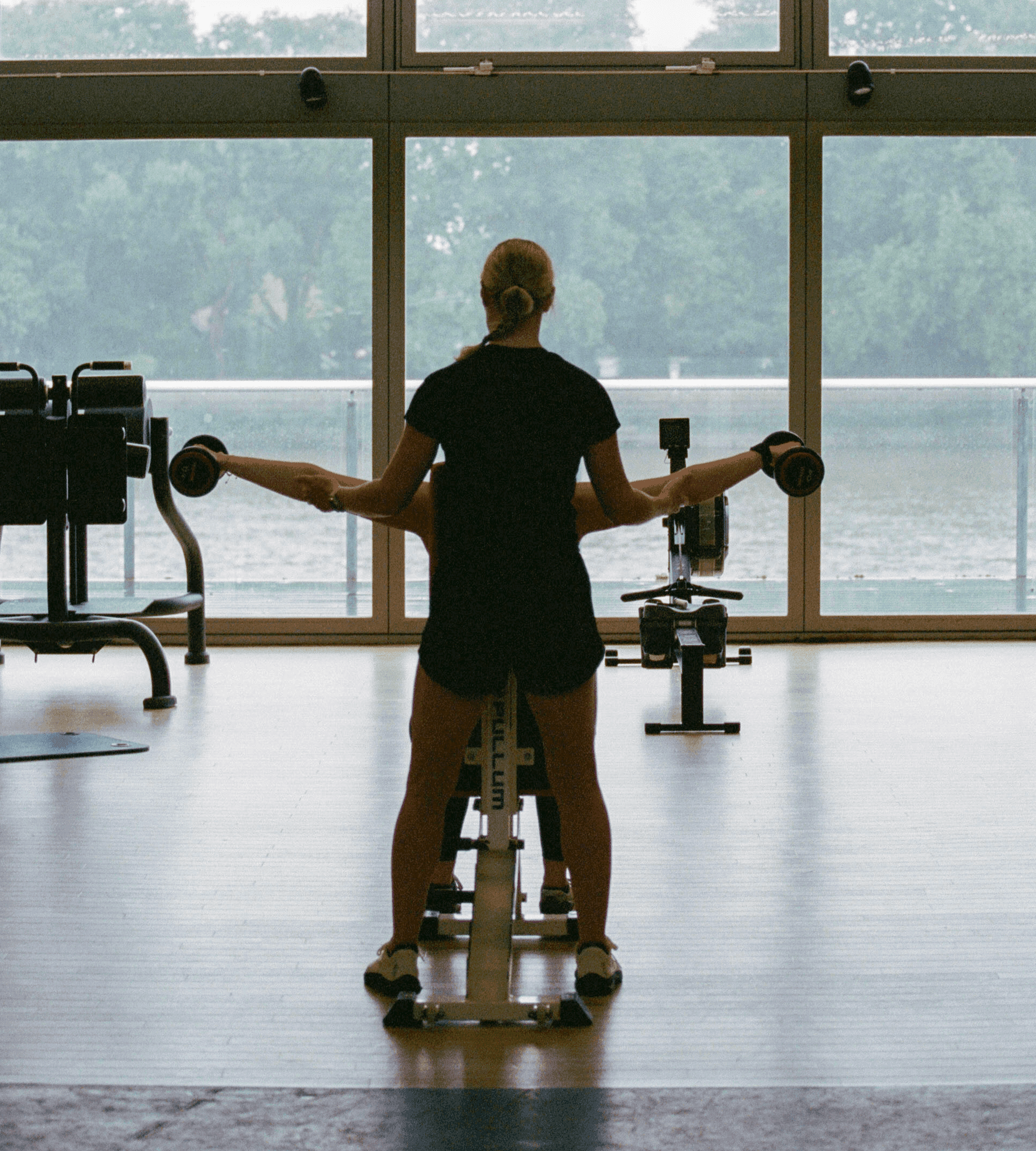 Personal trainer helping client with fitness