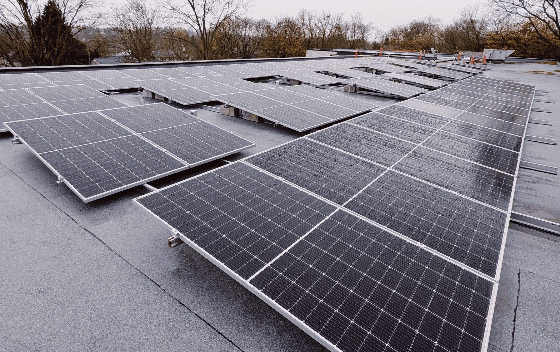 Wet Solar panels on a commercial rooftop in oxford county on a cloudy day