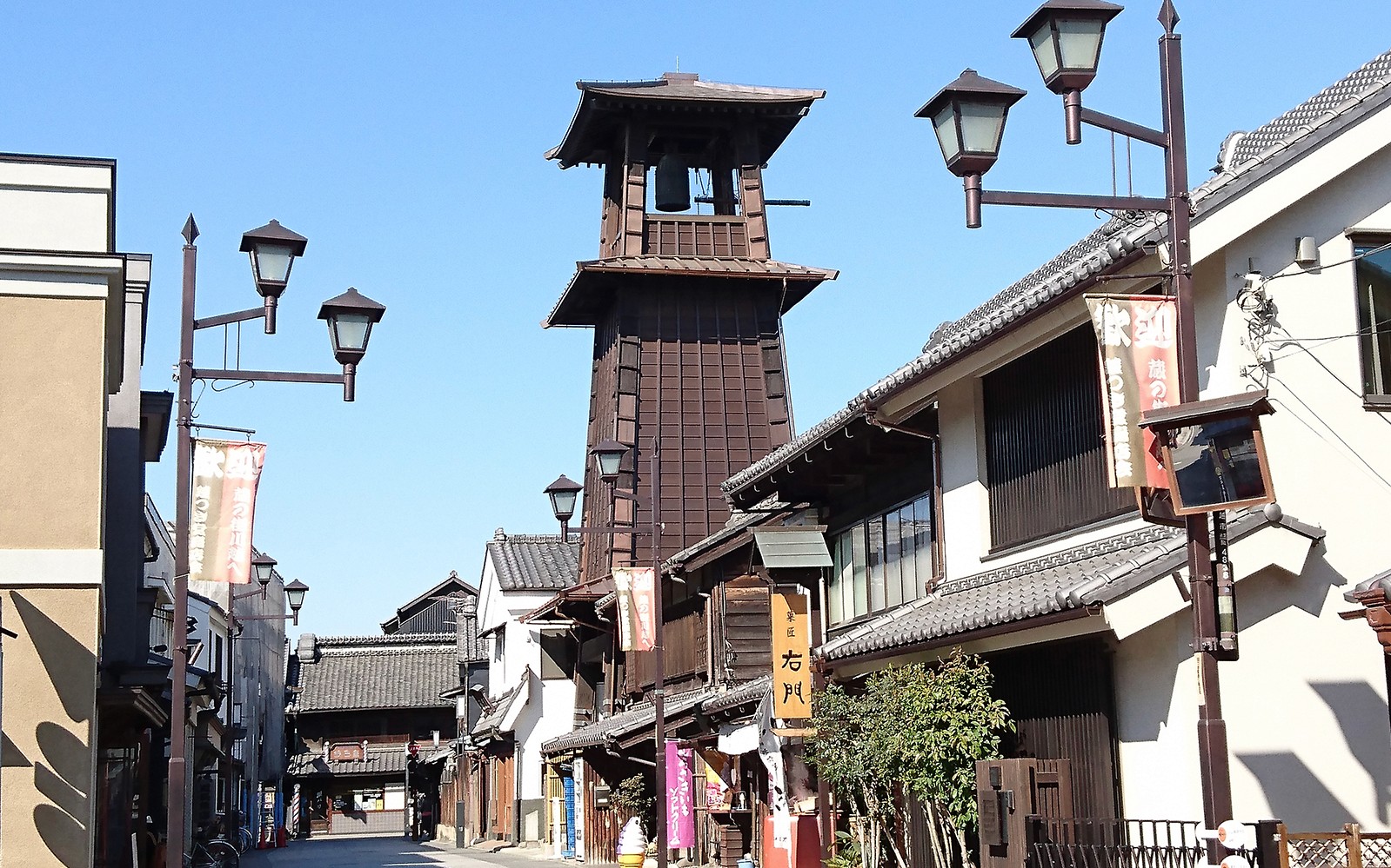 Historic bell tower in Kawagoe, Japan, along a traditional street, accessible with Seibu Pass.