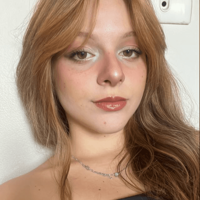 Sara is a client smiling to the camera happily