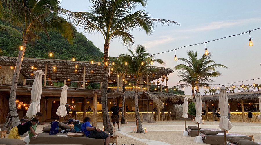 Vibrant Ungasan beach club at dusk. Discover prime commercial and residential real estate with our agents.