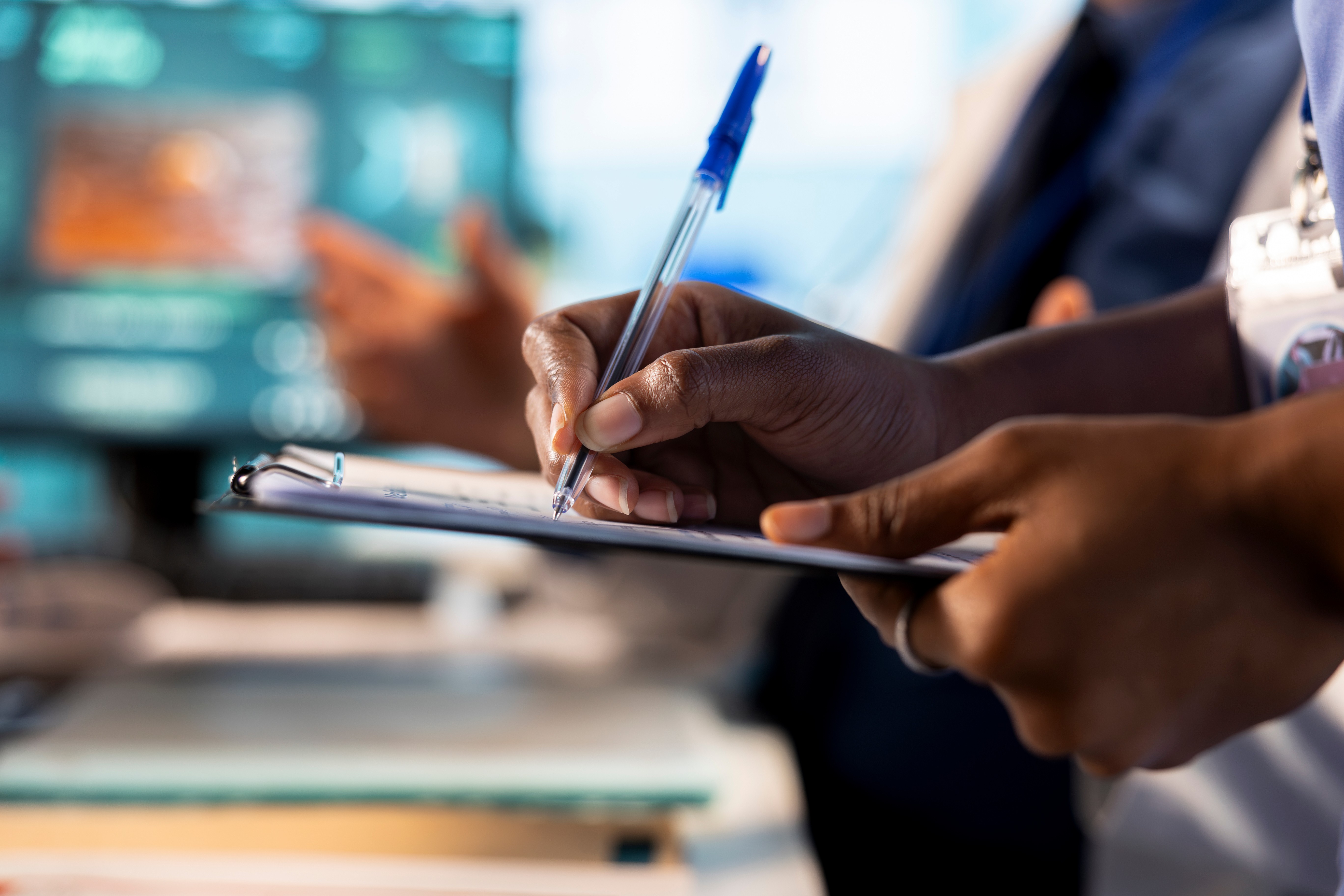 In chemical manufacturing lab,close up shot of a hand pouring liquid in a small glass bottle