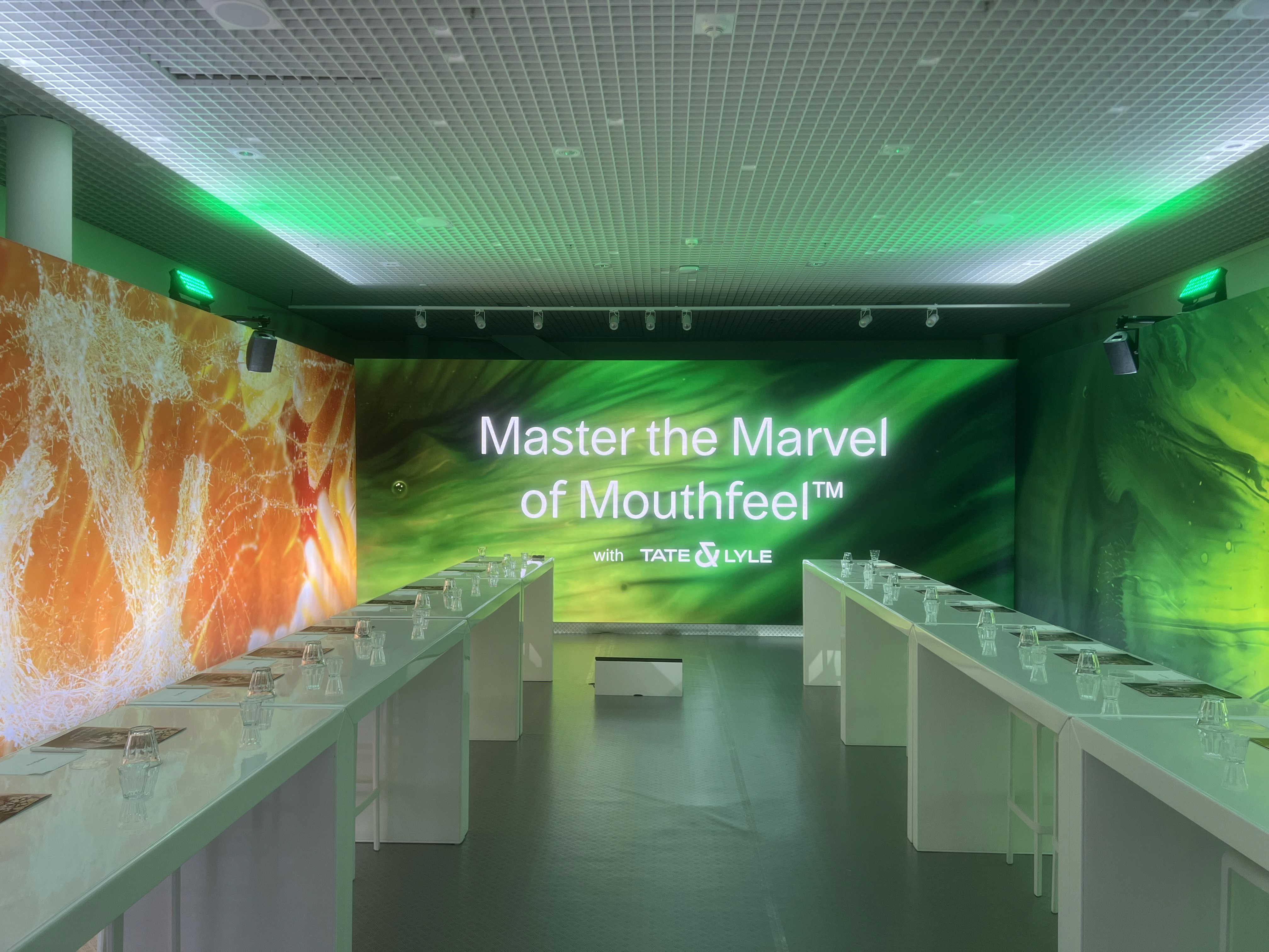 Tate and Lyle immersive event space with large video backdrop and colourful printed side walls