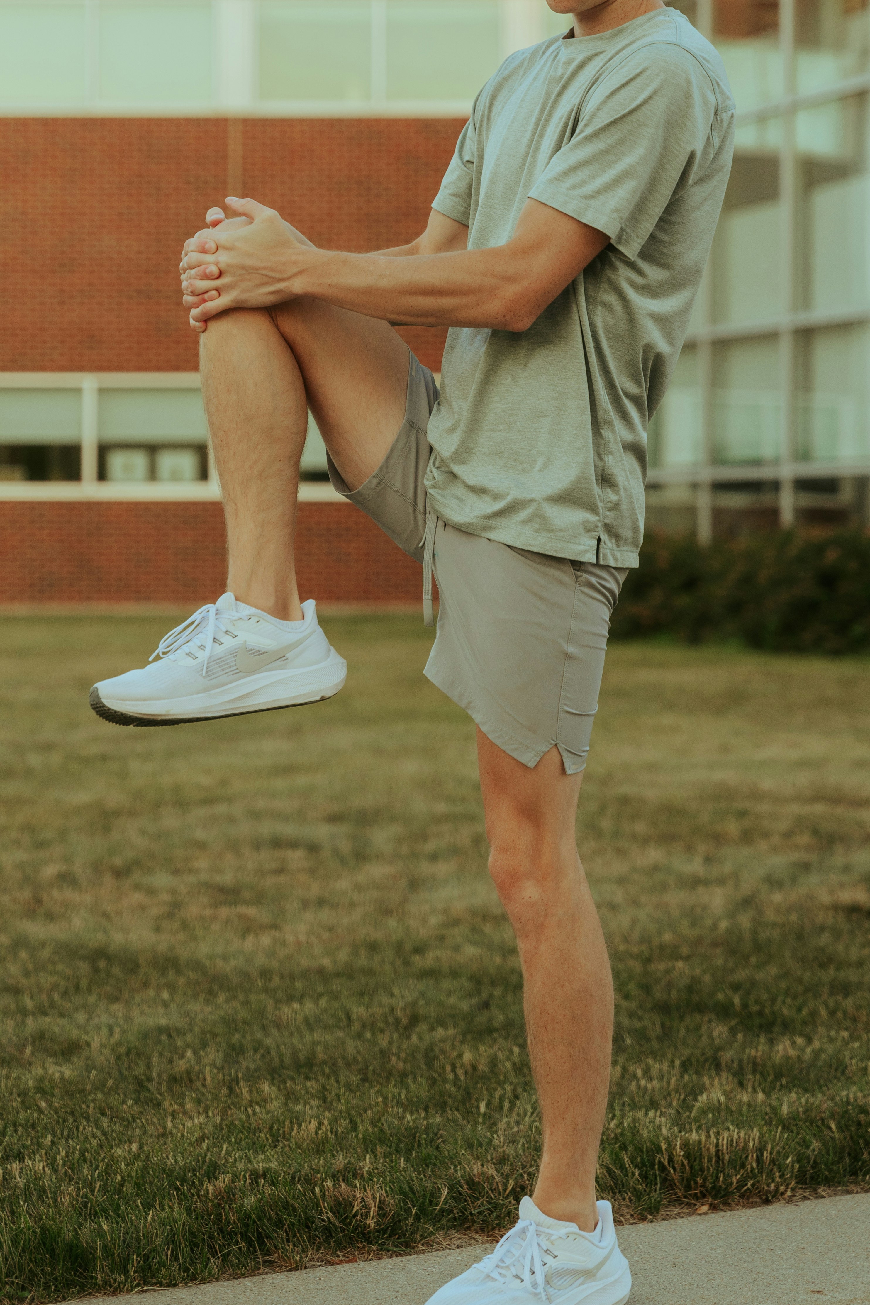 a man sitting on a skateboard on a sidewalk