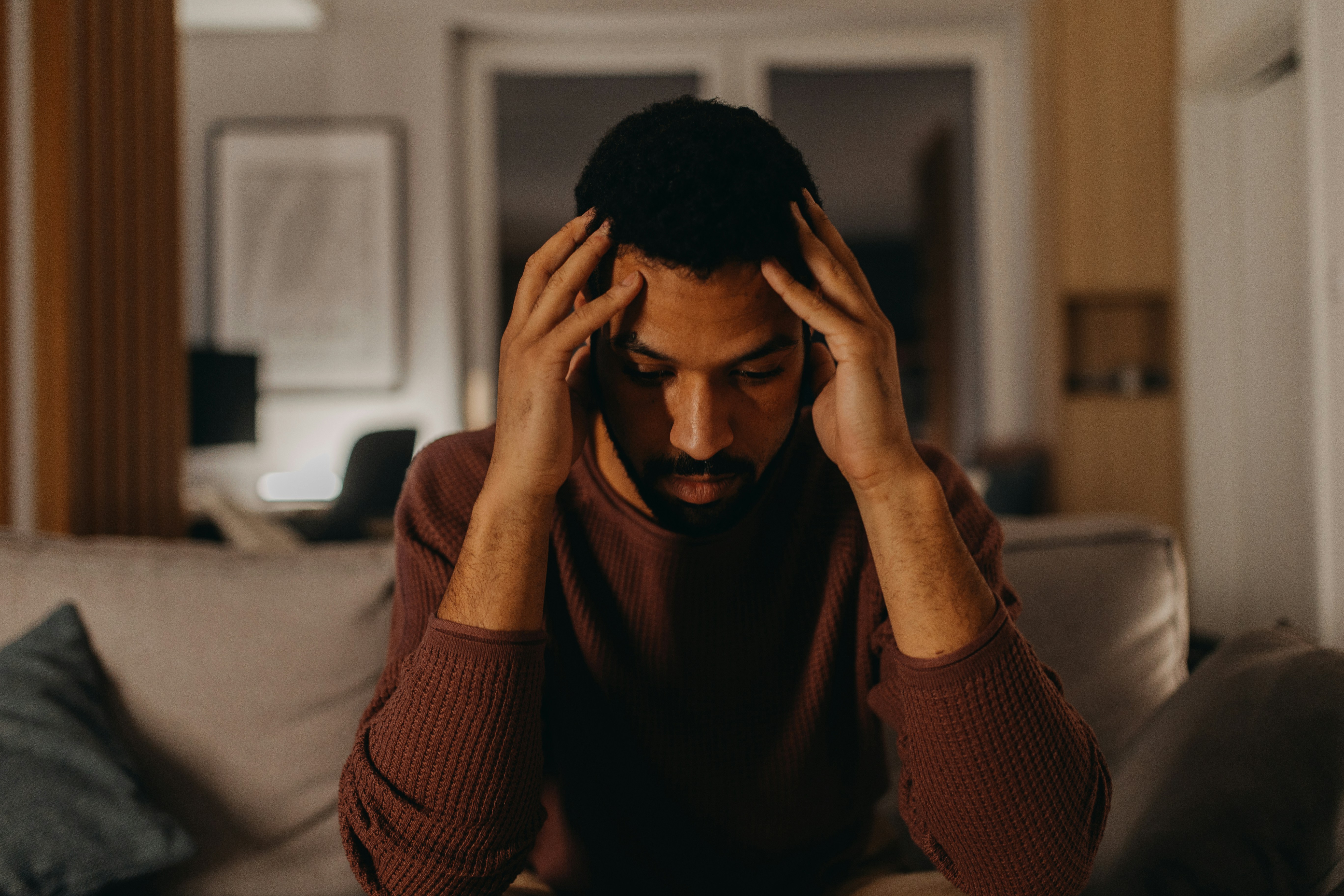 man holding head in his hands