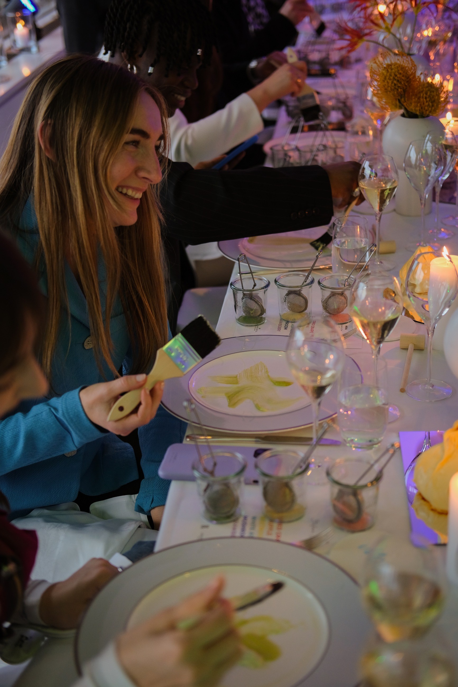 A guest painting a plate at the dinner table