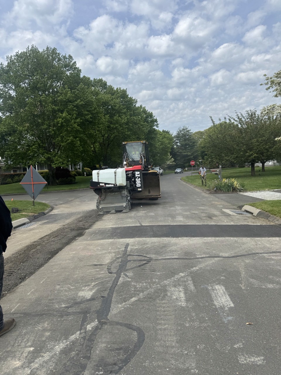 Milling train working down a leafy street, by A&M Construction Enterprises