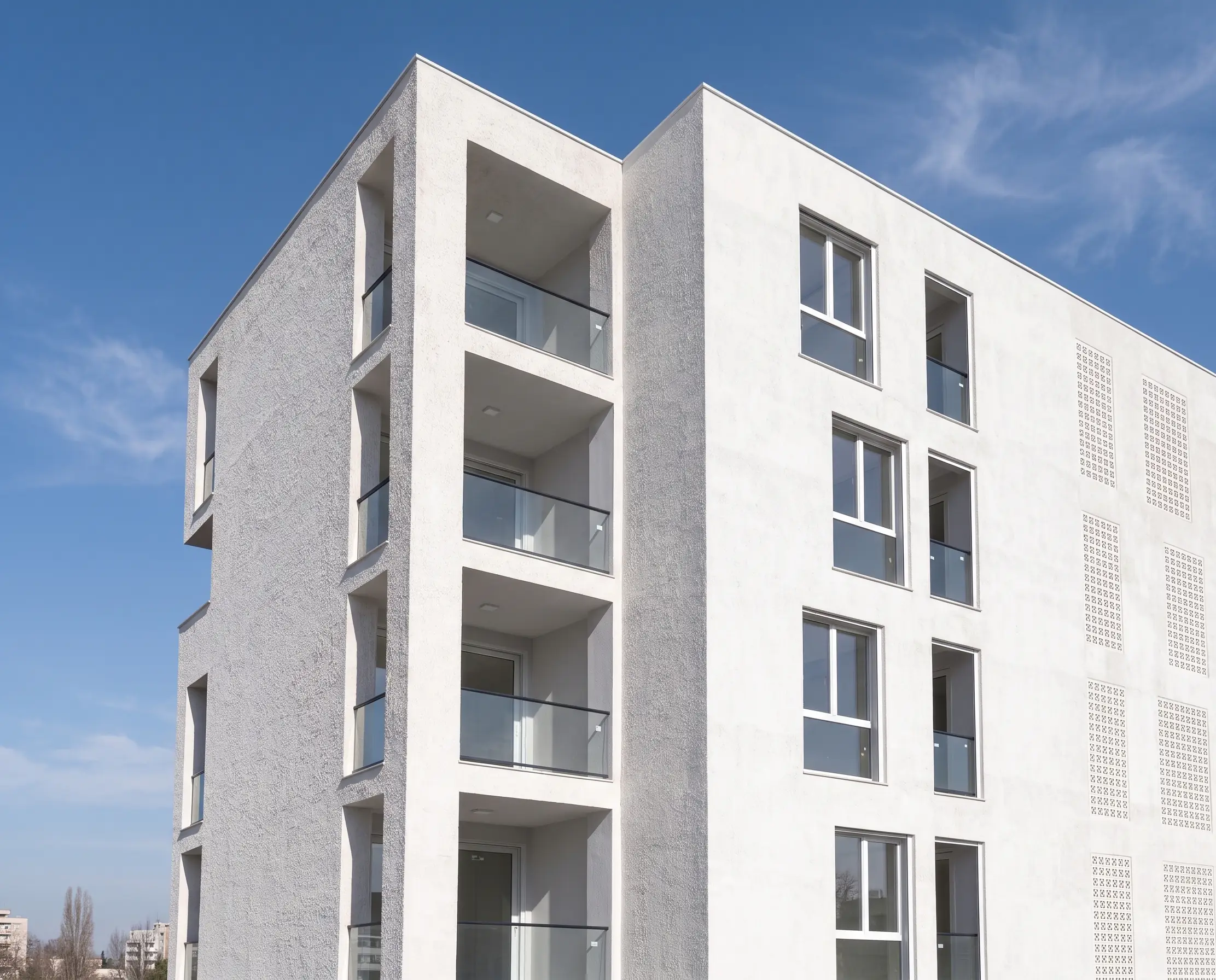Döşemealtı No.48: white-fronted apartment building with balconies against a blue sky